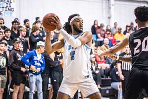 Nakavieon White holding the basketball away from defense.